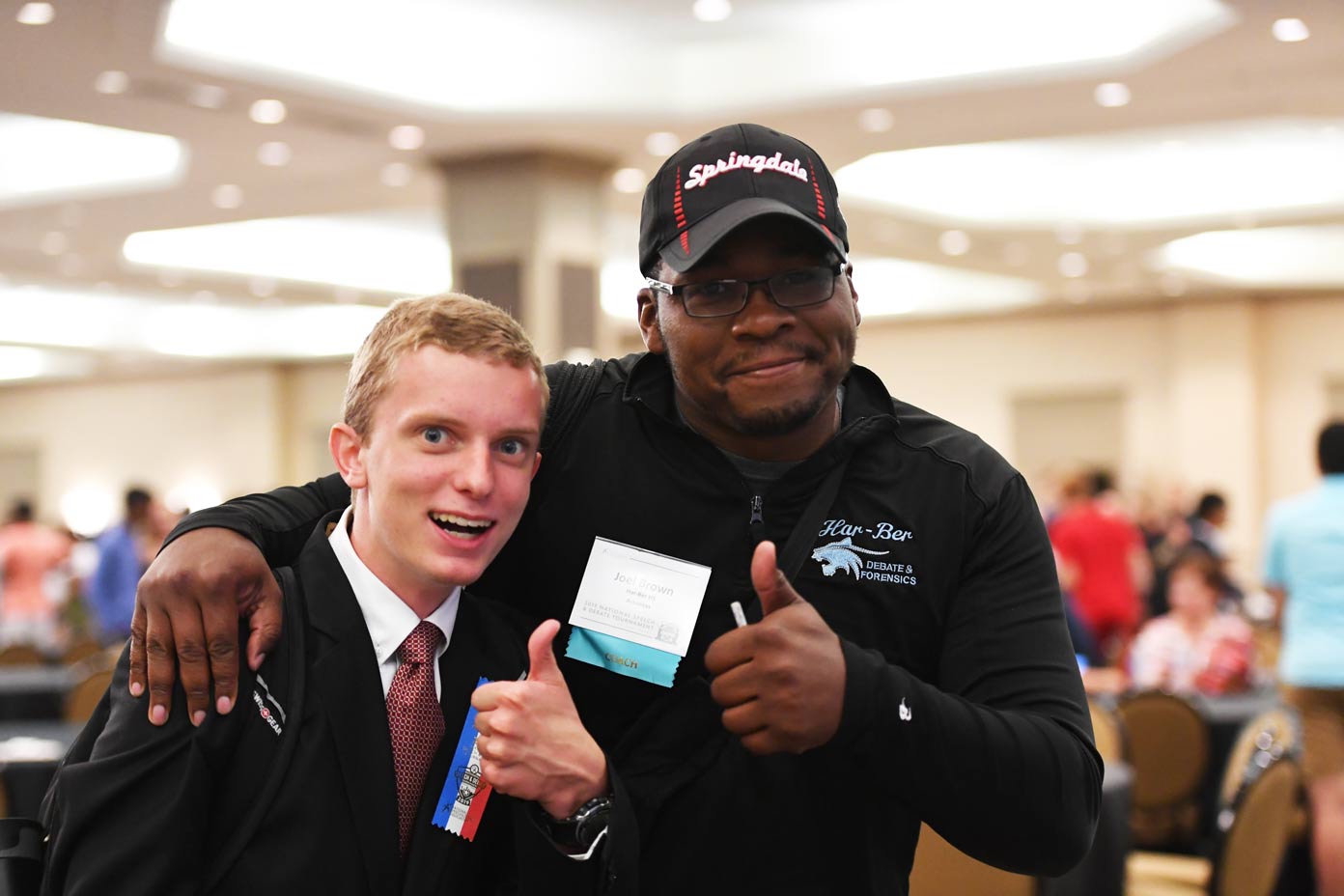 Coach and student standing together at a tournament