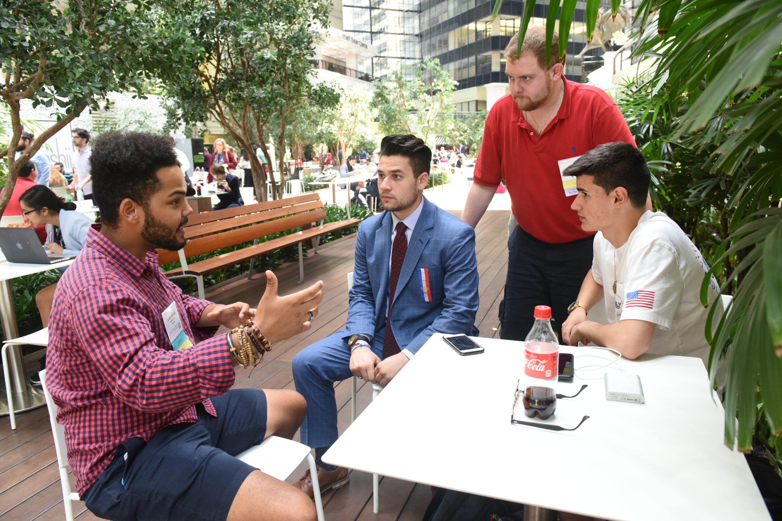 Four people having a discussion at a table.